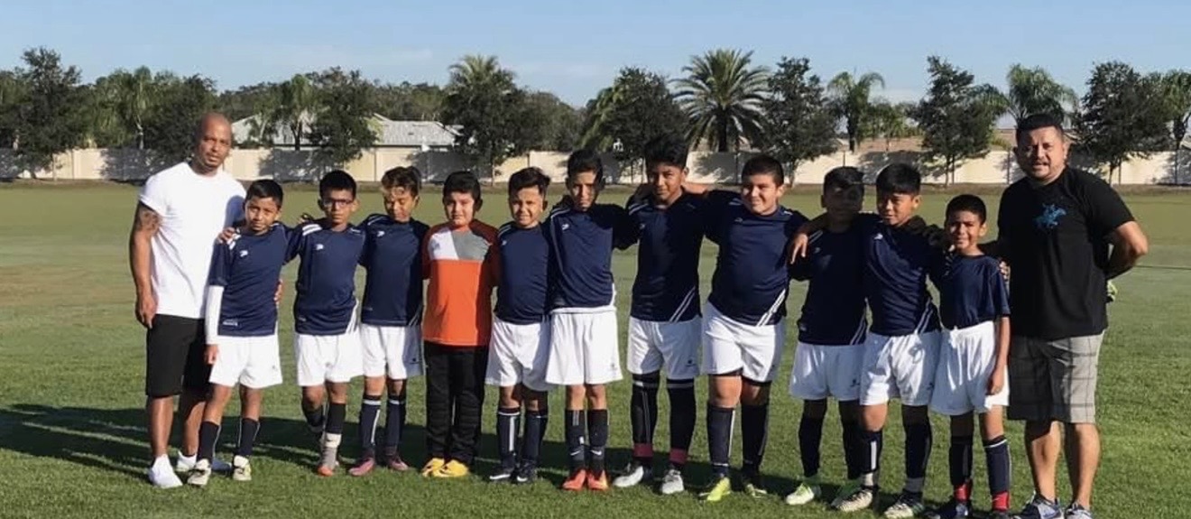 Youth team lined up with coaches before a match