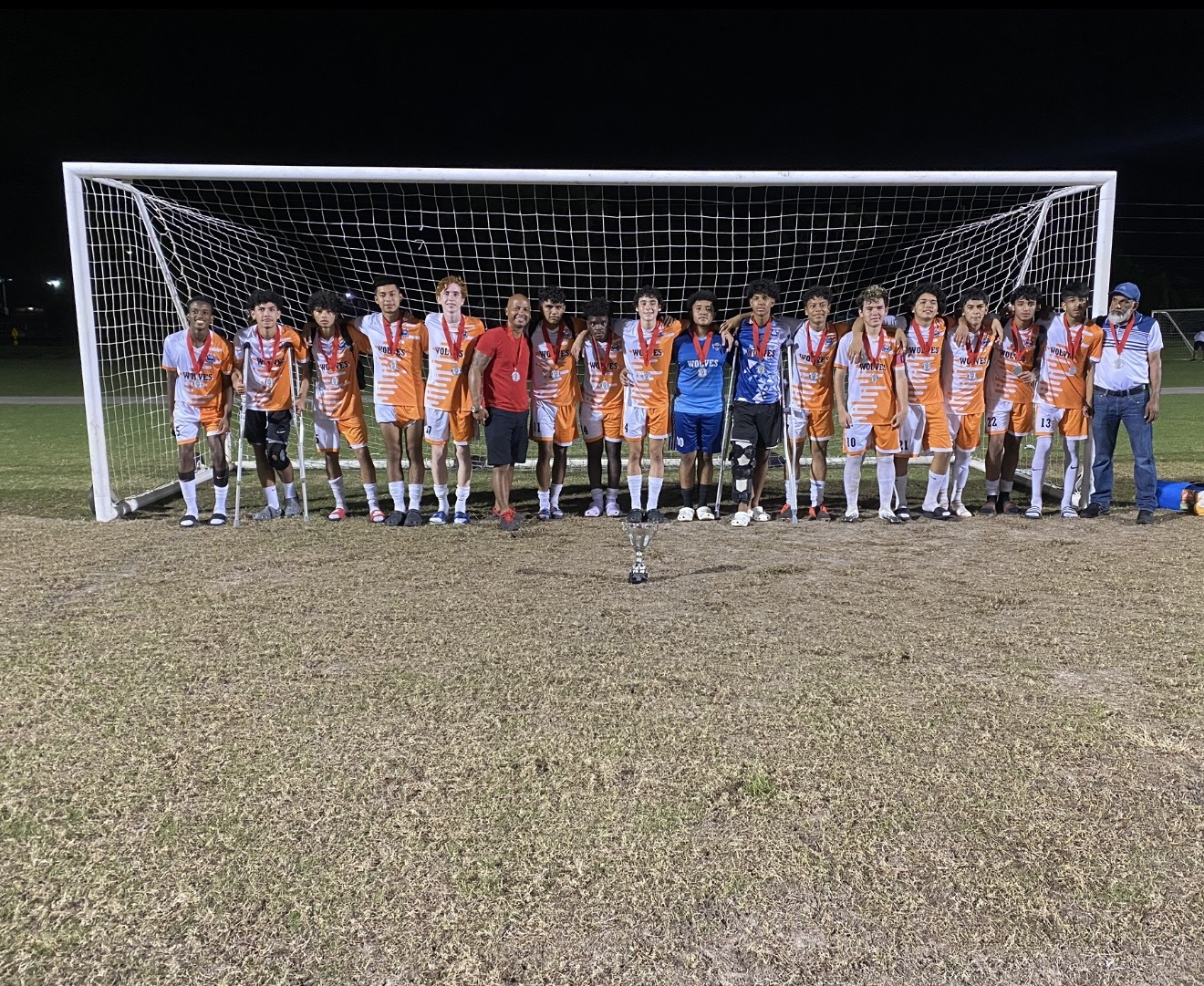 Wolves with medals and trophy under the lights