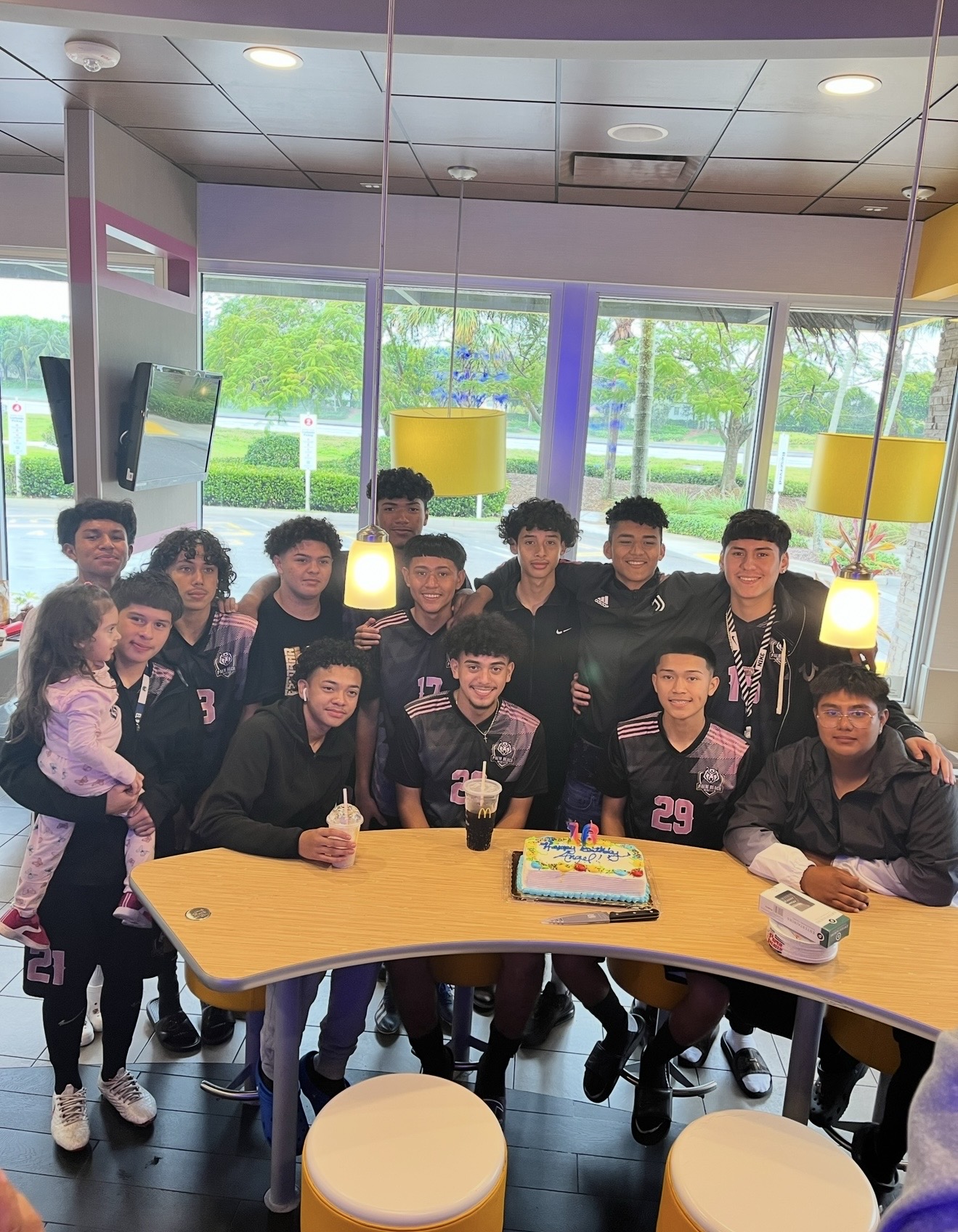 Team celebrating a birthday together off the field