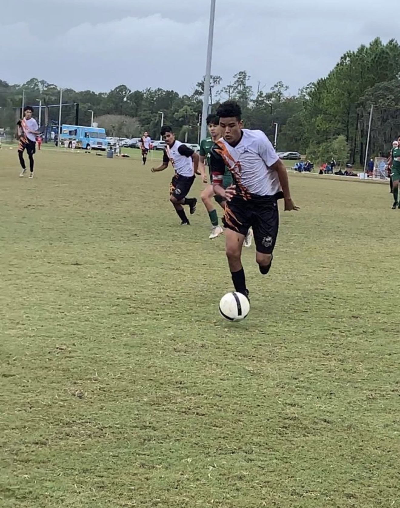 Wolves player driving the ball up the field